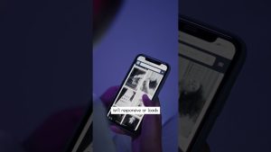 A person holds a smartphone displaying a partially loaded website with images and text—a caption reads: isnt responsive or loads. The dimly lit, blue and purple background highlights one of the common local SEO mistakes in Malaysia.